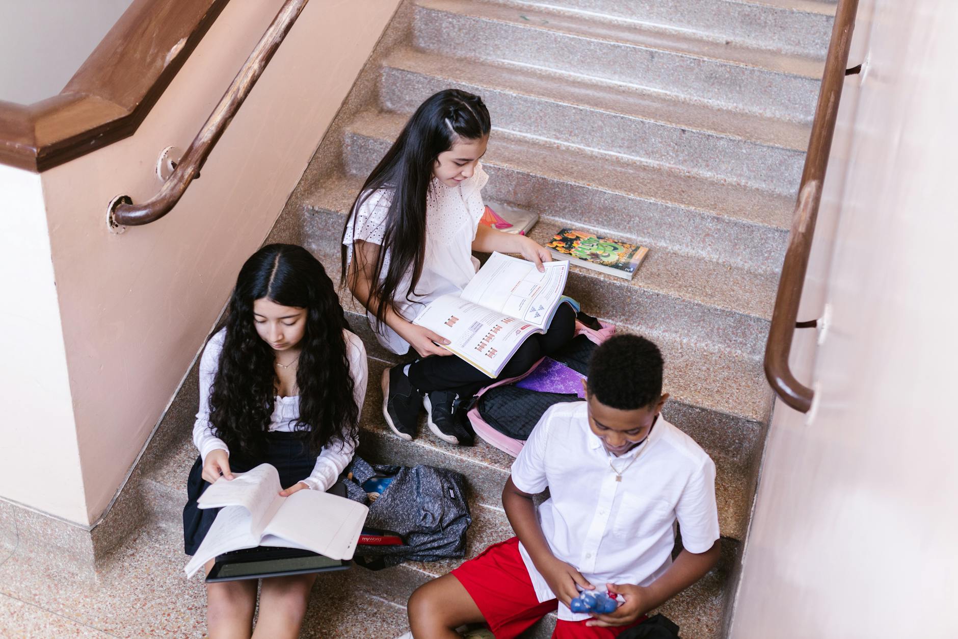 students on the stairs reading books